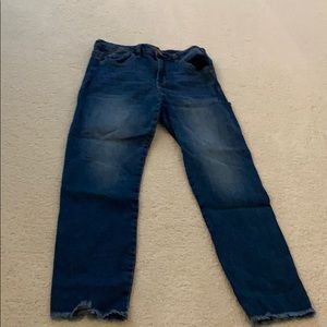 Dark denim jeans frayed at the bottom